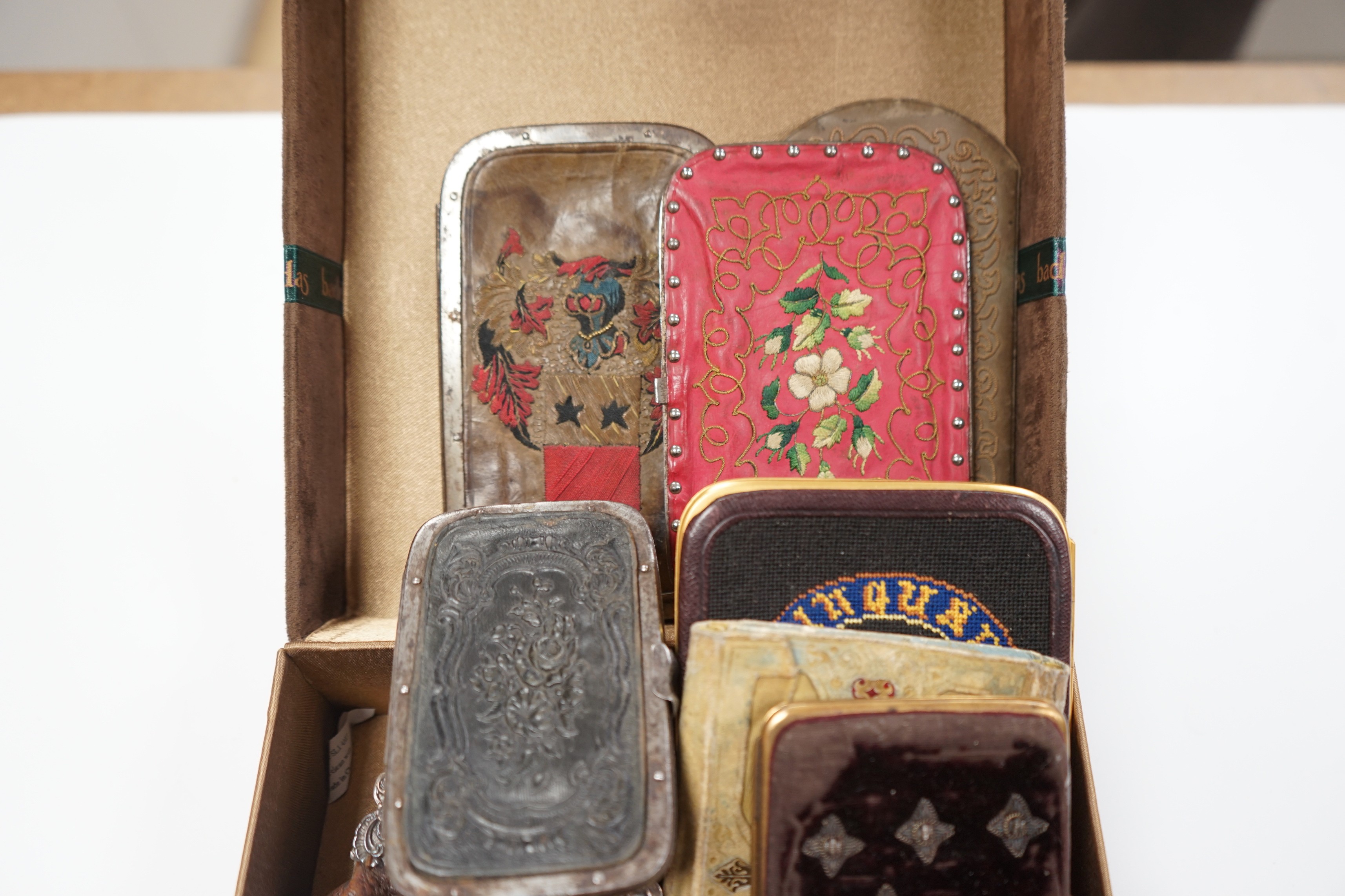 A collection of early 19th century and later embroidered, petite point, leather cut steel and velvet purses card cases etc